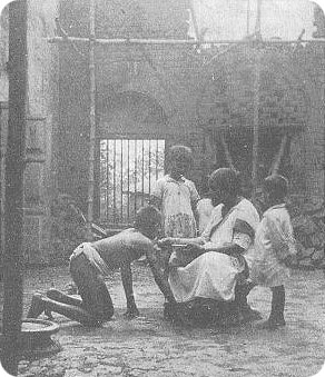 Kamala receiving biscuits from Mrs Singh's hand